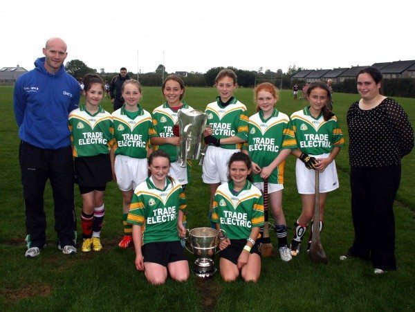 Ardagh National School Camogie Team with James Ryan (Limerick County Player) and Sile Moynihan ( Limerick Intermediate Ladies Goalkeeper and Teacher in Desmond College) holding the the Munster Senior Hurling Cup and the Minor Hurling Cup at Desmond College Camogie Blitz