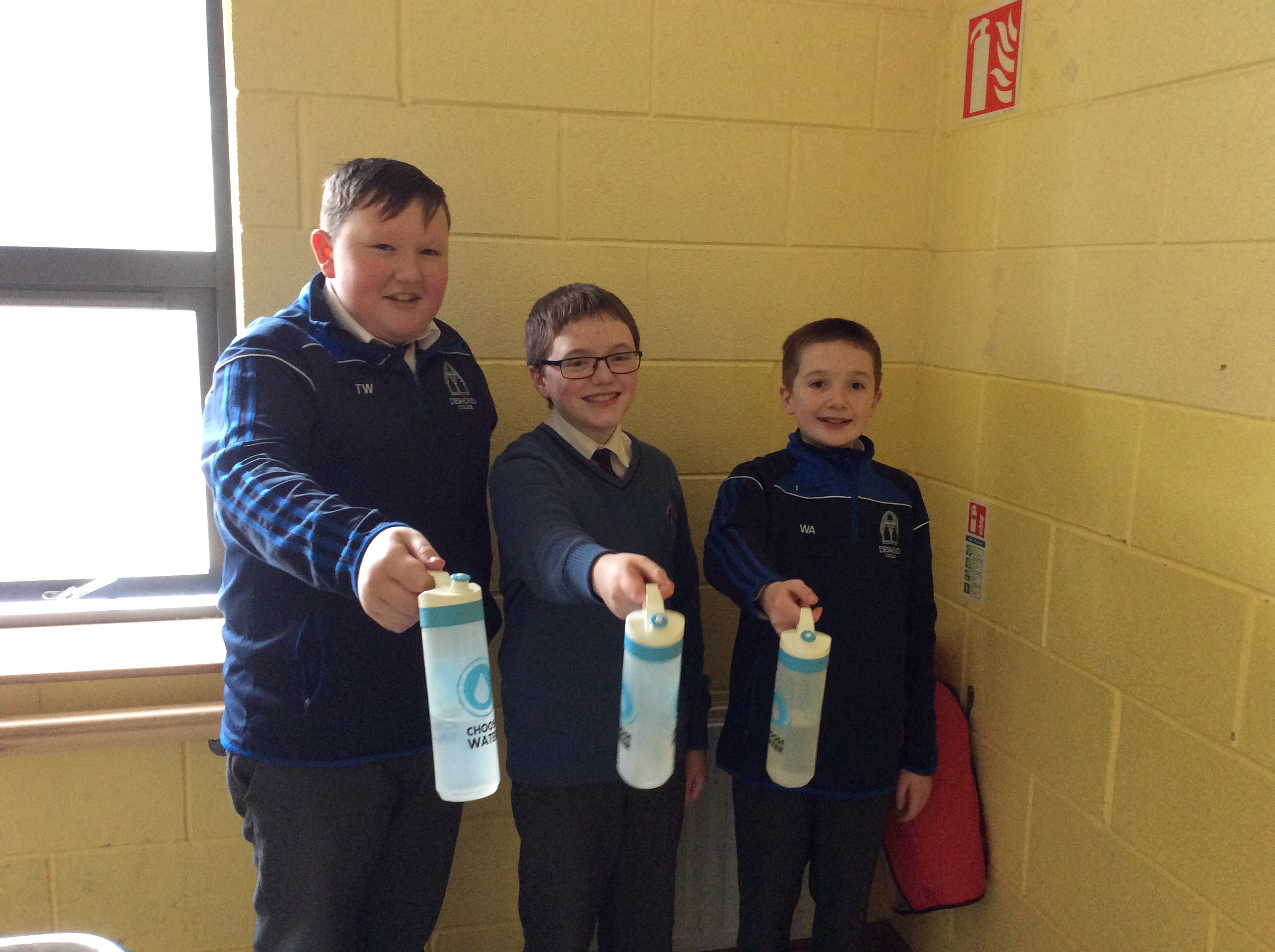 Tomás White, Patrick O Grady and William Ahern showing off their new refillable water bottles